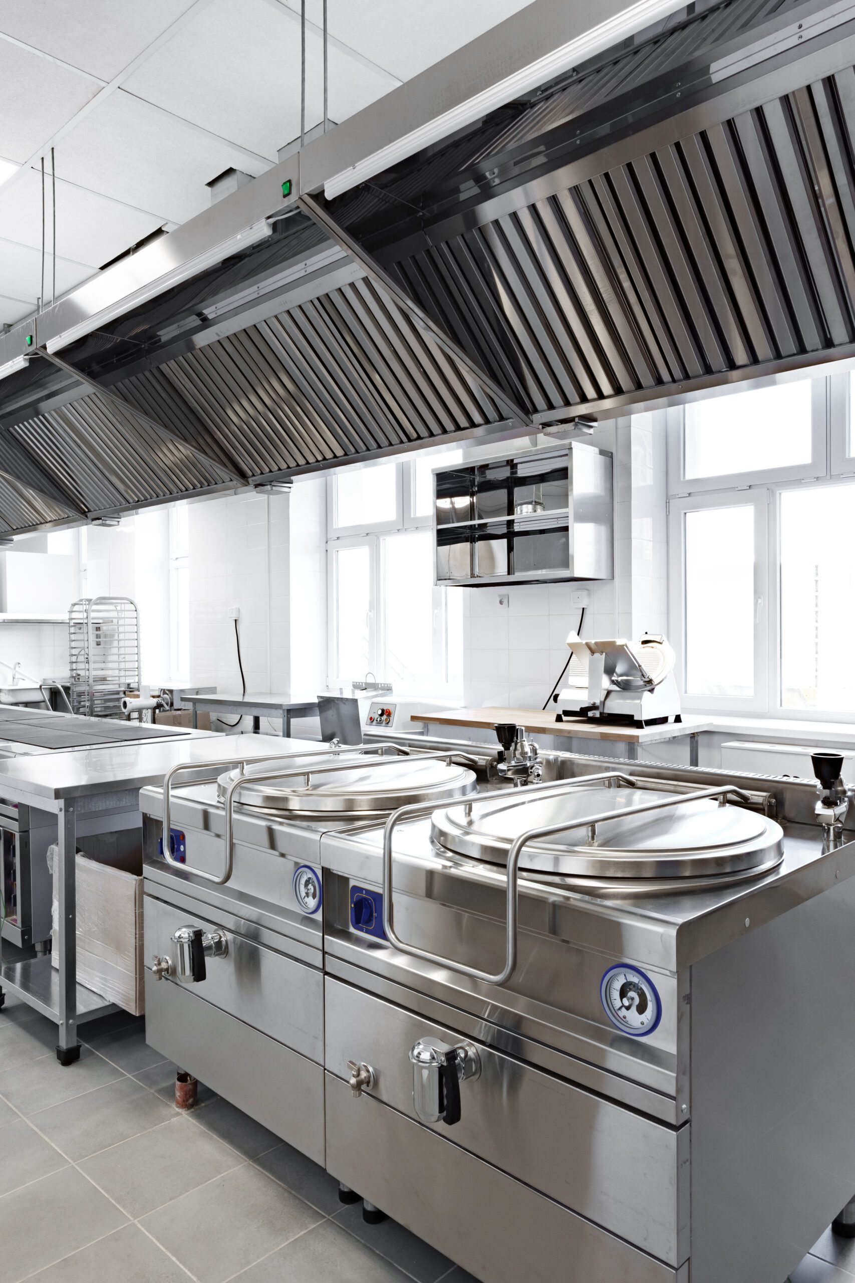 modern commercial kitchen equipped with stainless steel appliances and ventilation system for culinary operations